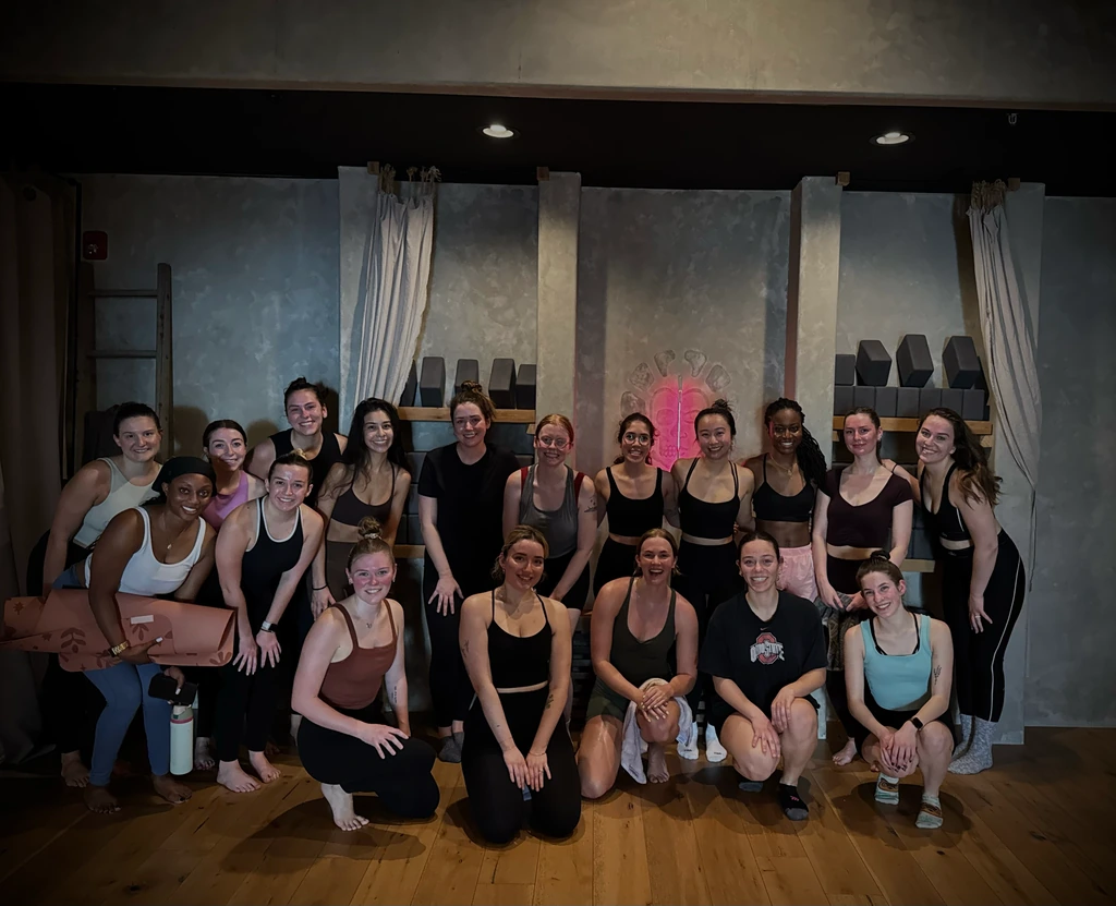 The Kitty & Vibe group gathered in the REWILD YOGA practice room.